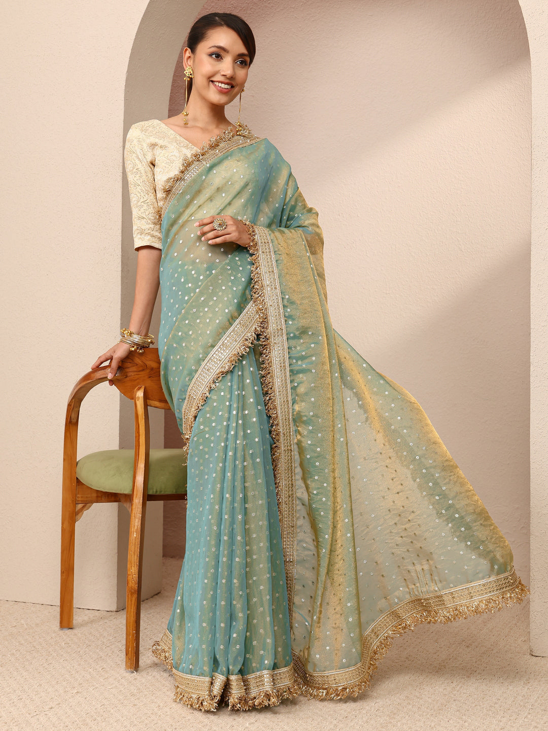 Green Woven Design Tissue Saree
With Unstitched Blouse Piece